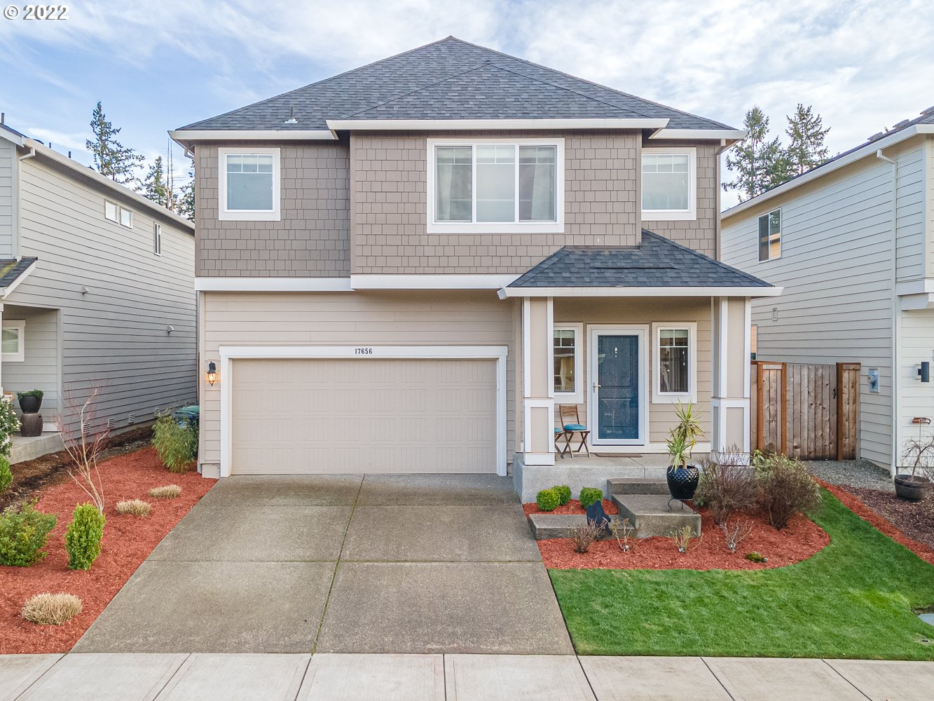 17656 Southeast Pinnacles Street Damascus, OR 97089 - Photo 1 of 31 a front view of a house with yard and outdoor seating