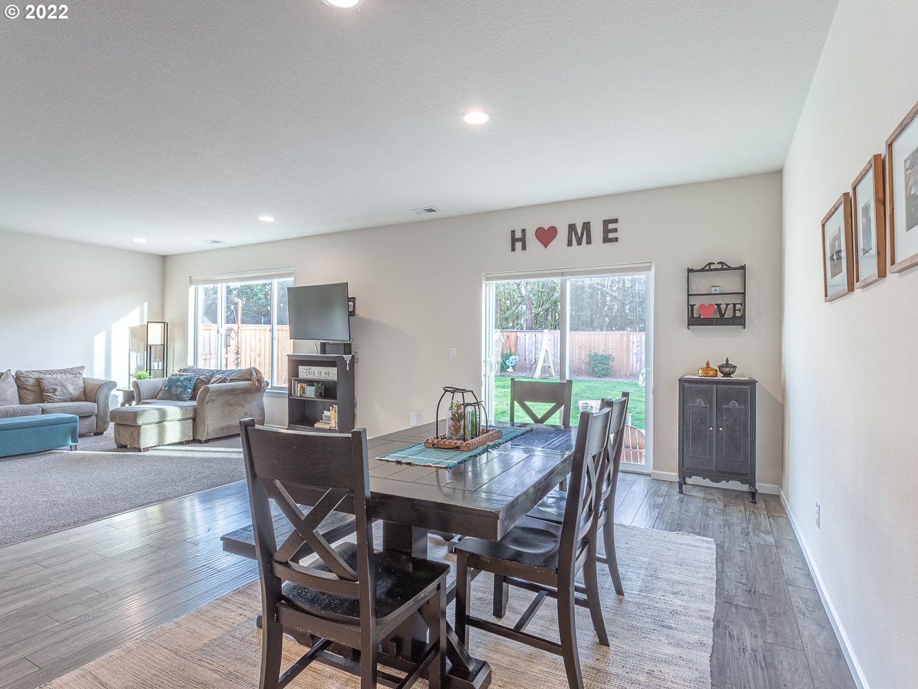17656 Southeast Pinnacles Street Damascus, OR 97089 - Photo 11 of 31 a view of a dining room with furniture and wooden floor