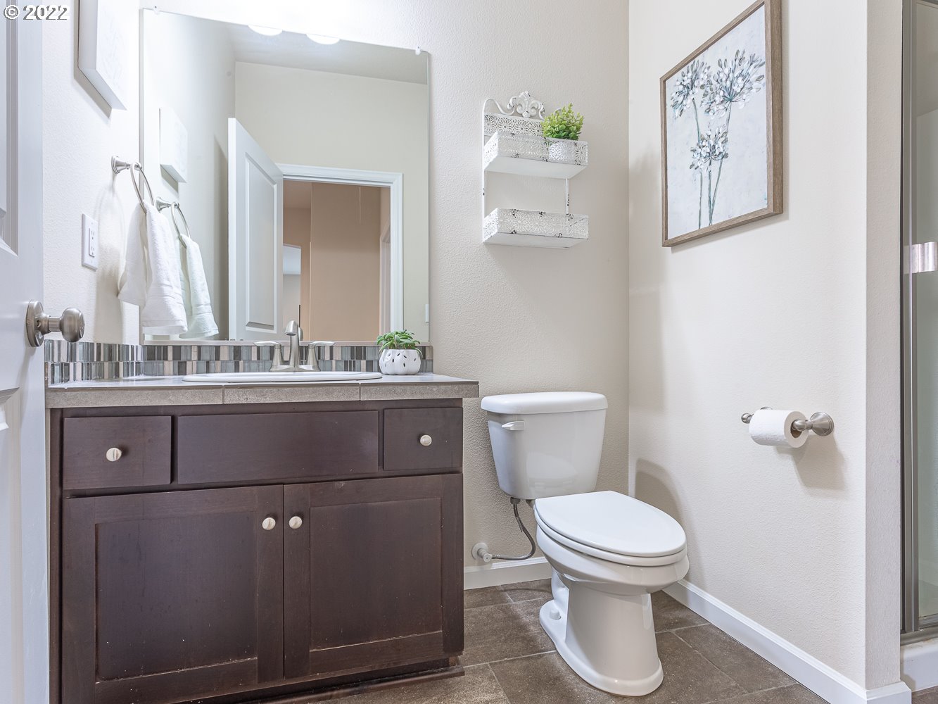 17656 Southeast Pinnacles Street Damascus, OR 97089 - Photo 12 of 31 a bathroom with a toilet sink and mirror