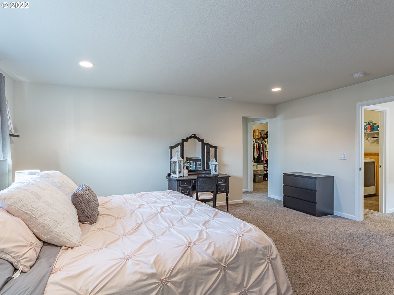 17656 Southeast Pinnacles Street Damascus, OR 97089 - Photo 14 of 31 a bedroom with a bed and a dresser