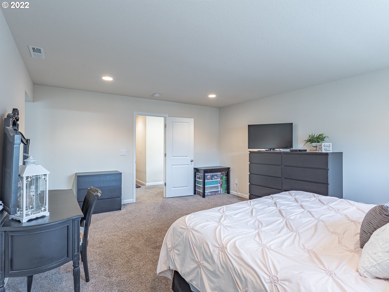 17656 Southeast Pinnacles Street Damascus, OR 97089 - Photo 15 of 31 a bedroom with a bed and a dresser