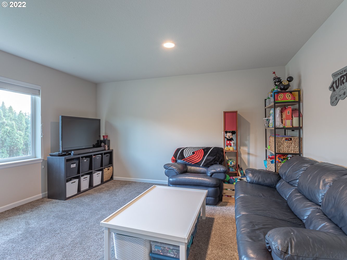 17656 Southeast Pinnacles Street Damascus, OR 97089 - Photo 19 of 31 a living room with furniture and a flat screen tv