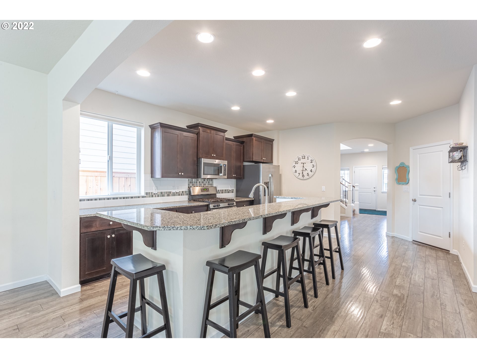 17656 Southeast Pinnacles Street Damascus, OR 97089 - Photo 2 of 31 a kitchen with a table and chairs in it