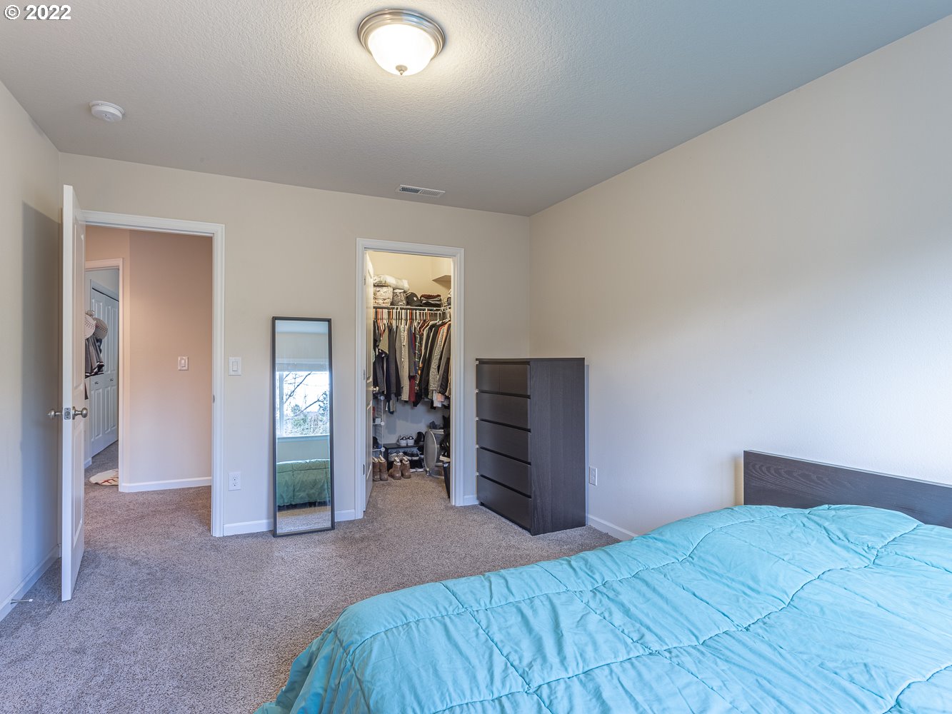 17656 Southeast Pinnacles Street Damascus, OR 97089 - Photo 26 of 31 a bedroom with a bed and a dresser