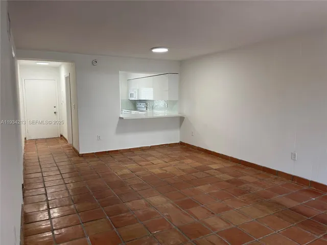 a view of a kitchen with wooden floor and a sink