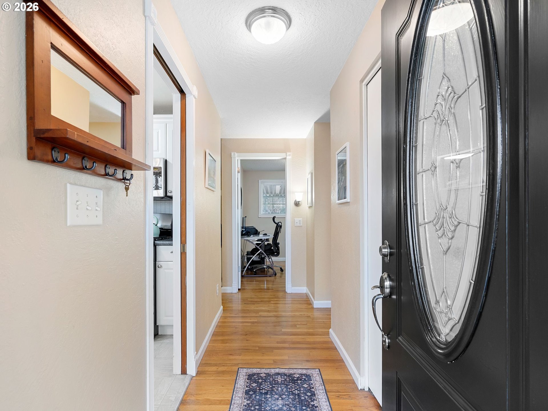 2036 Sallal Road Woodburn, OR 97071 - Photo 2 of 25 a view of a hallway with wooden floor and windows