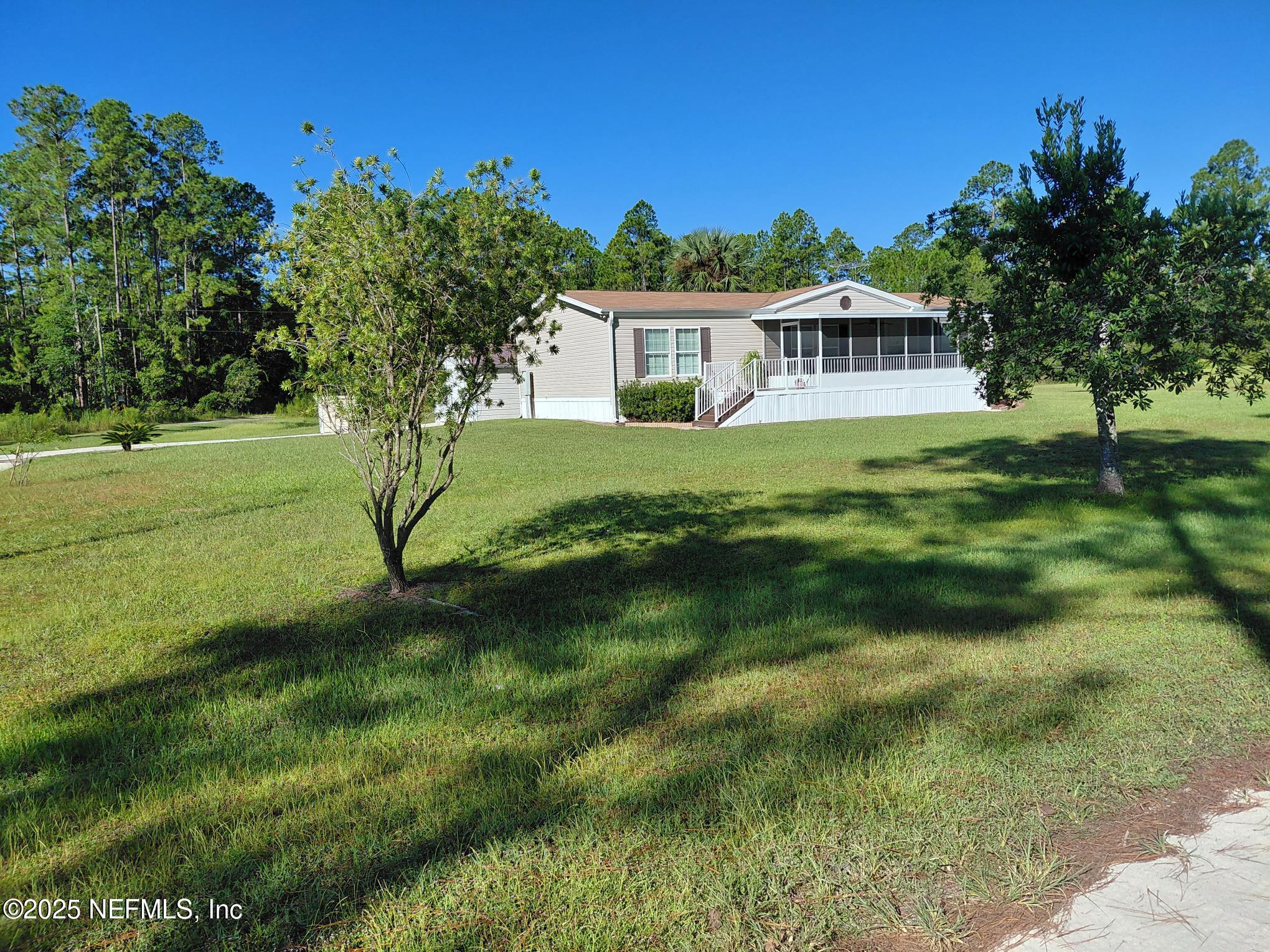 a view of a house with a backyard