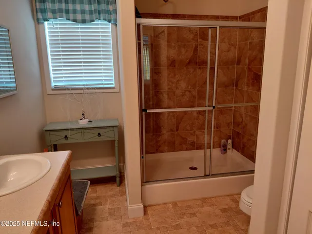a bathroom with a shower and a sink
