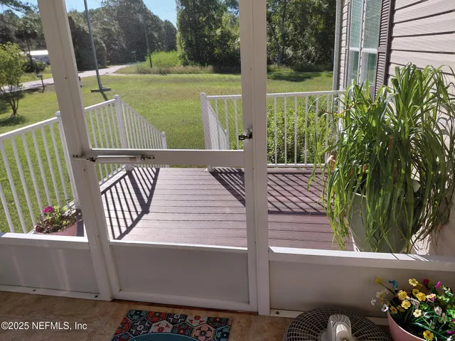a view of a balcony with wooden floor and outdoor space