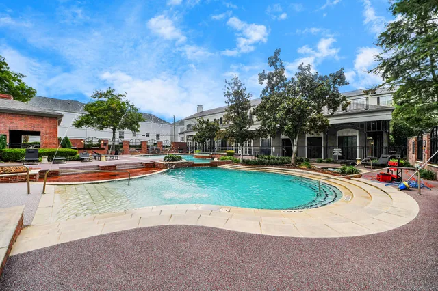 a view of a house with swimming pool and sitting area