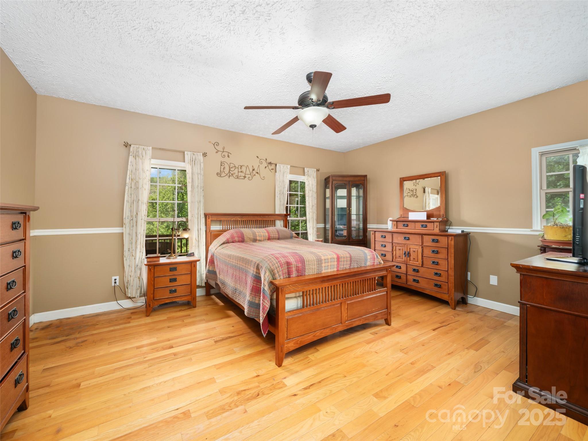 2216 Beans Creek Road Bakersville, NC 28705 - Photo 14 of 39 a bedroom with a bed and wooden floor