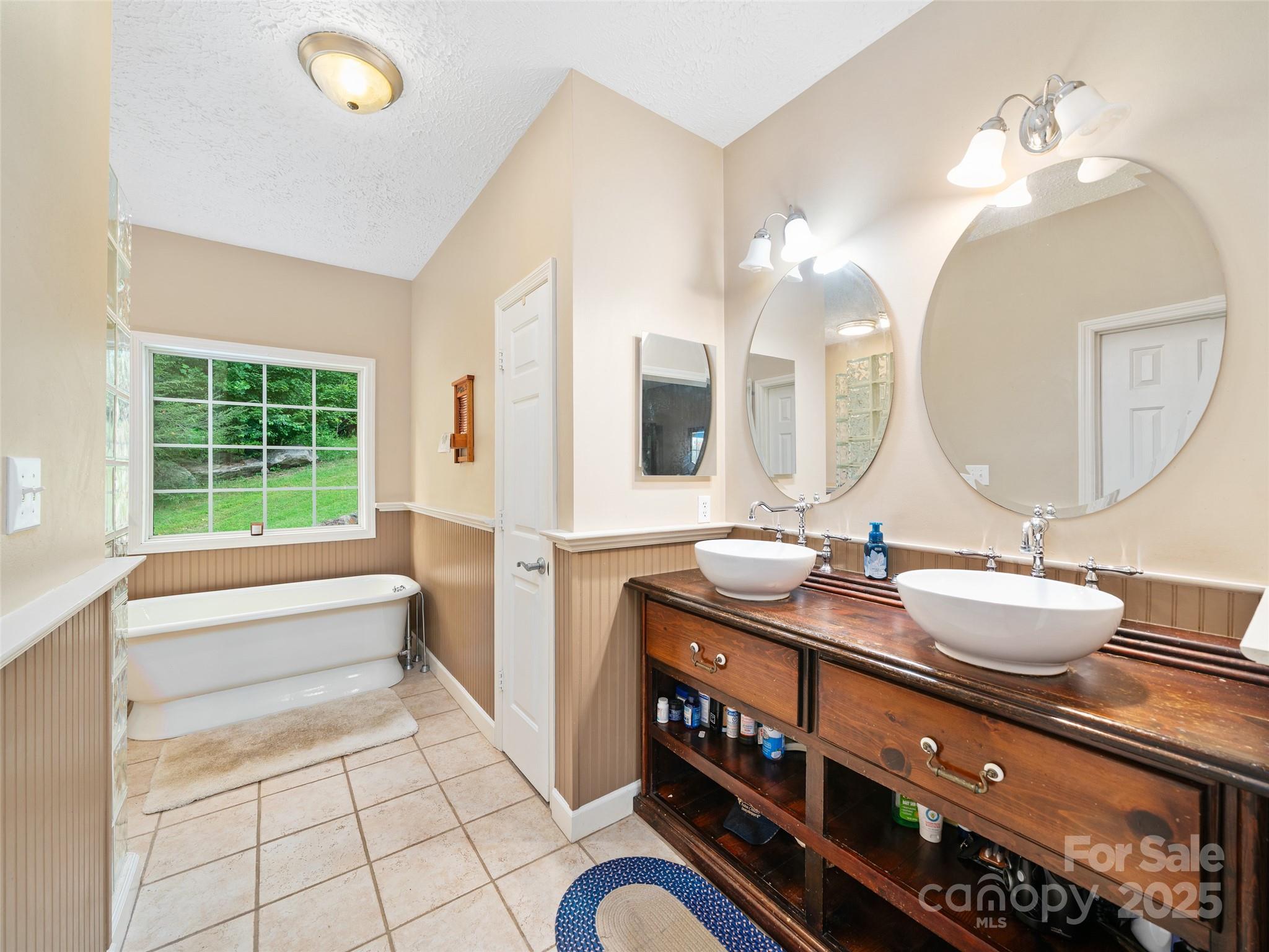 2216 Beans Creek Road Bakersville, NC 28705 - Photo 17 of 39 a bathroom with a sink a vanity and a mirror