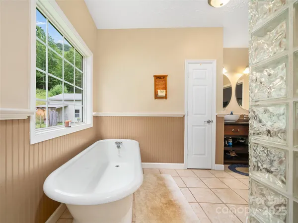 a spacious bathroom with a bathtub and a sink
