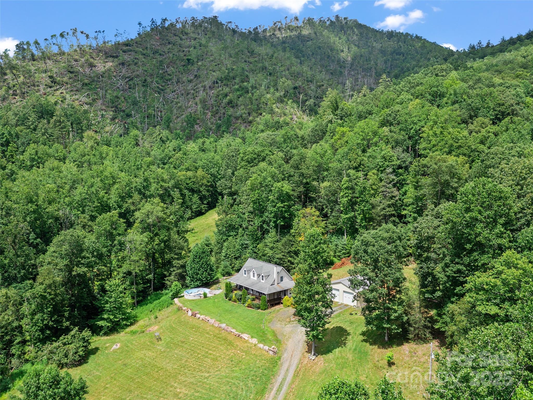 2216 Beans Creek Road Bakersville, NC 28705 - Photo 3 of 39 a backyard of a house with a yard and outdoor seating