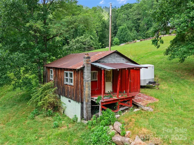 a backyard of a house with yard fire pit and outdoor seating