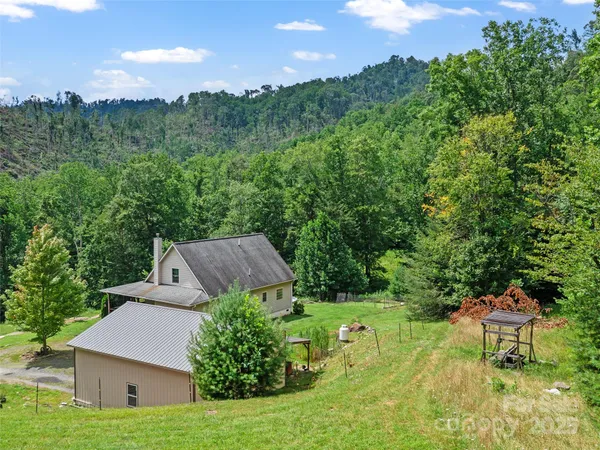 a view of a house with a yard and sitting area