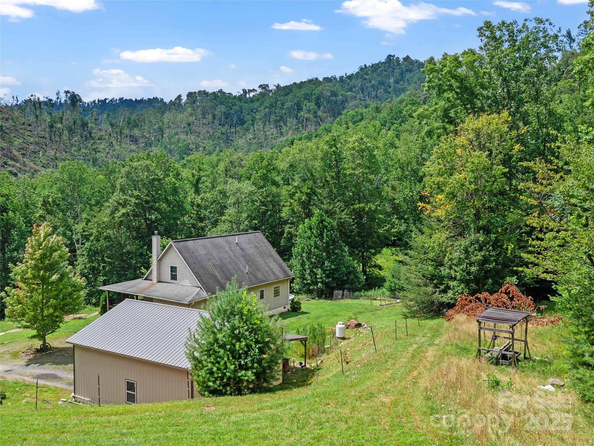 2216 Beans Creek Road Bakersville, NC 28705 - Photo 38 of 39 a view of a house with a yard and sitting area
