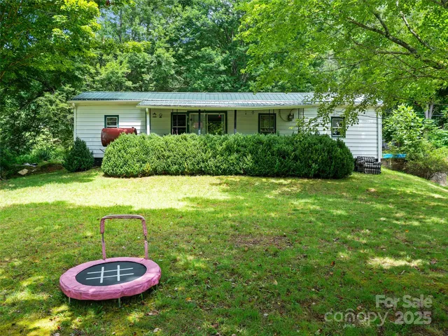 a view of a backyard with table and chairs