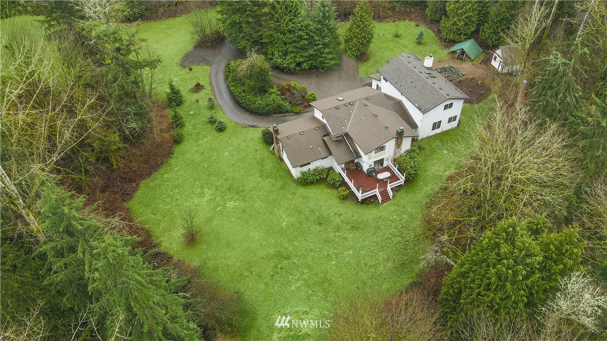 22217 61st Avenue Southeast Bothell, WA 98021 - Photo 1 of 37 an aerial view of a house with a garden and trees