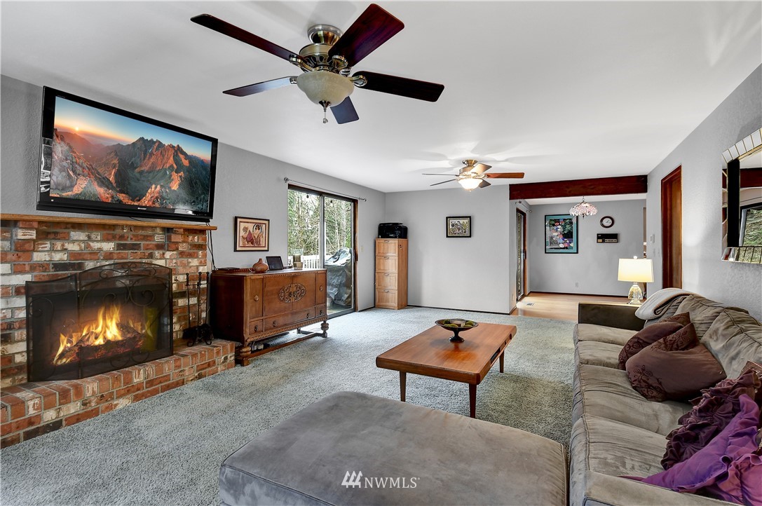 22217 61st Avenue Southeast Bothell, WA 98021 - Photo 16 of 37 a living room with furniture and a fireplace