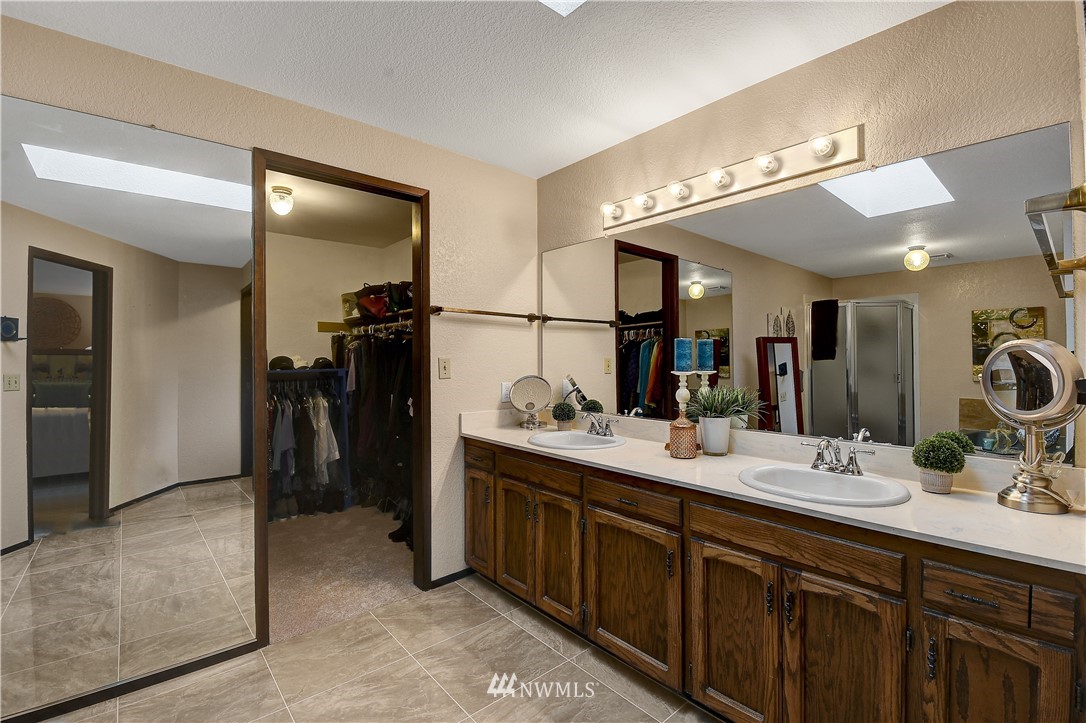 22217 61st Avenue Southeast Bothell, WA 98021 - Photo 20 of 37 a bathroom with a double vanity sink and a mirror