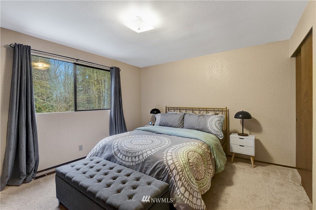 22217 61st Avenue Southeast Bothell, WA 98021 - Photo 22 of 37 a bedroom with a bed and a window