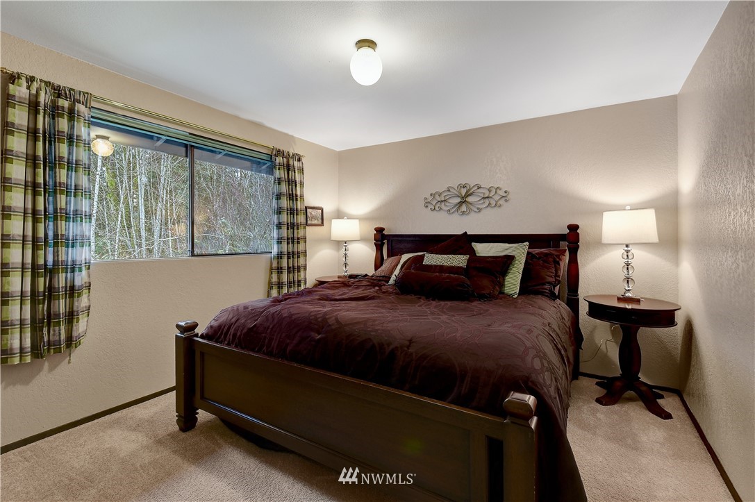 22217 61st Avenue Southeast Bothell, WA 98021 - Photo 23 of 37 a bedroom with a bed and window