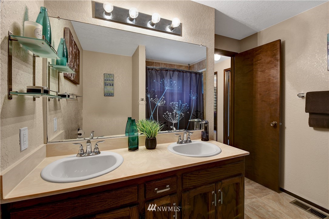 22217 61st Avenue Southeast Bothell, WA 98021 - Photo 24 of 37 a bathroom with a sink double vanity and a mirror