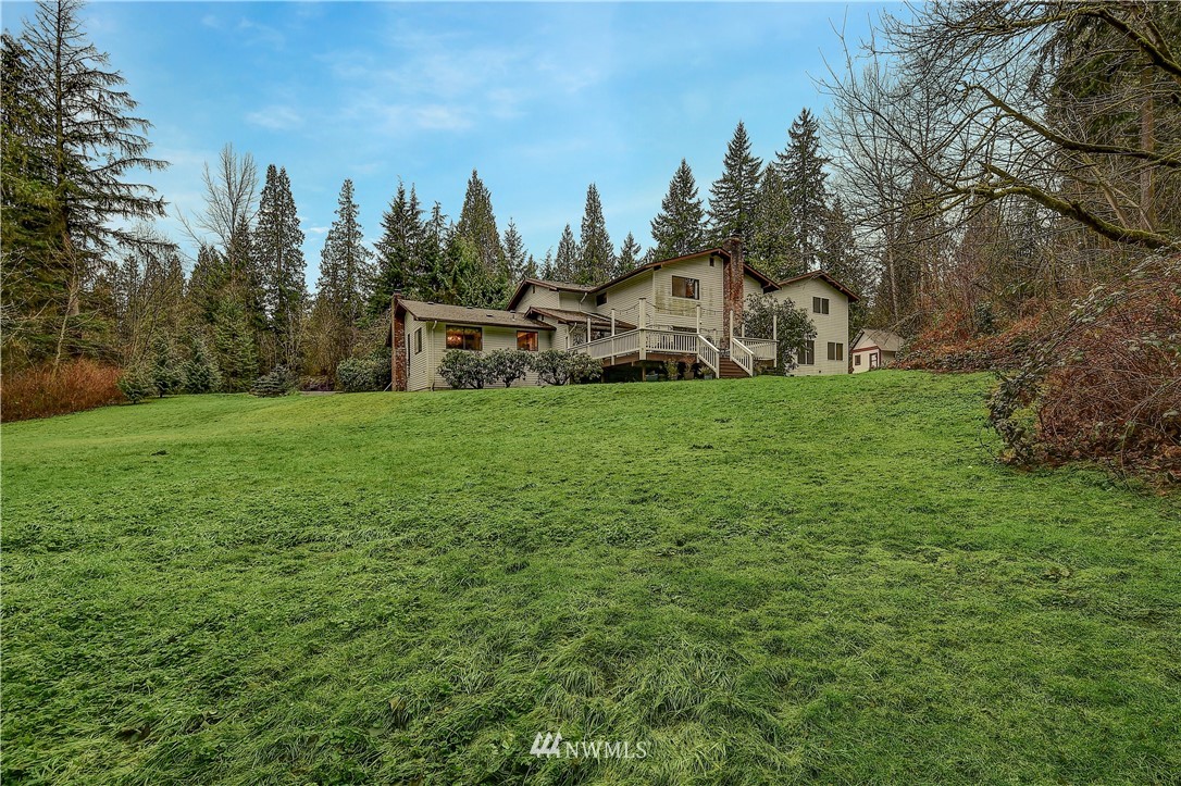 22217 61st Avenue Southeast Bothell, WA 98021 - Photo 29 of 37 a view of a house with a yard and trees