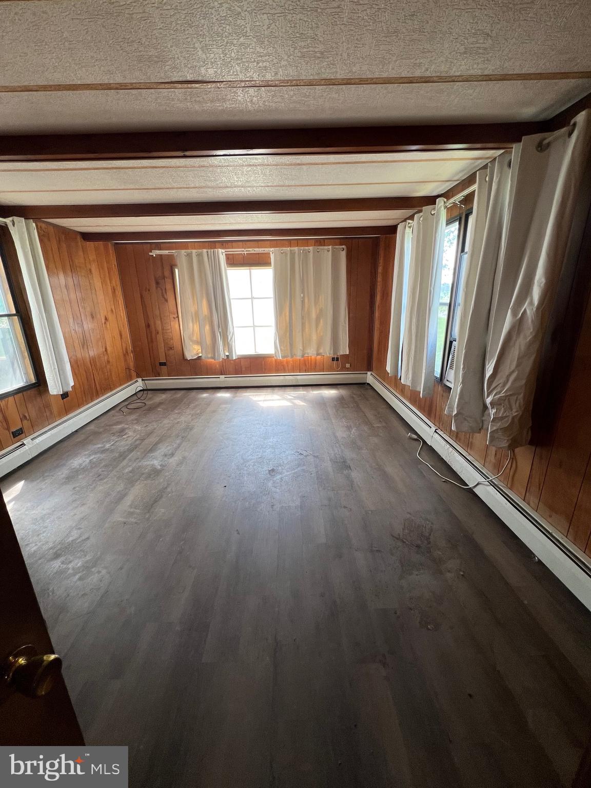 2318 Rockvale Road Lancaster, PA 17602 - Photo 3 of 15 a view of an empty room with wooden floor and a window