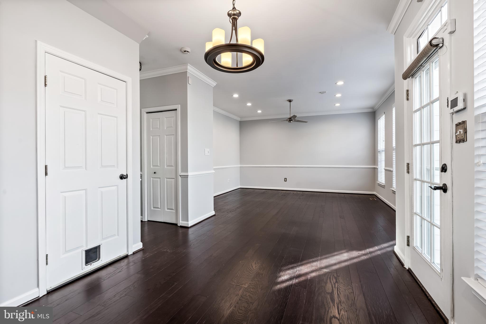43112 Demerrit Street Chantilly, VA 20152 - Photo 15 of 42 an empty room with wooden floor and windows