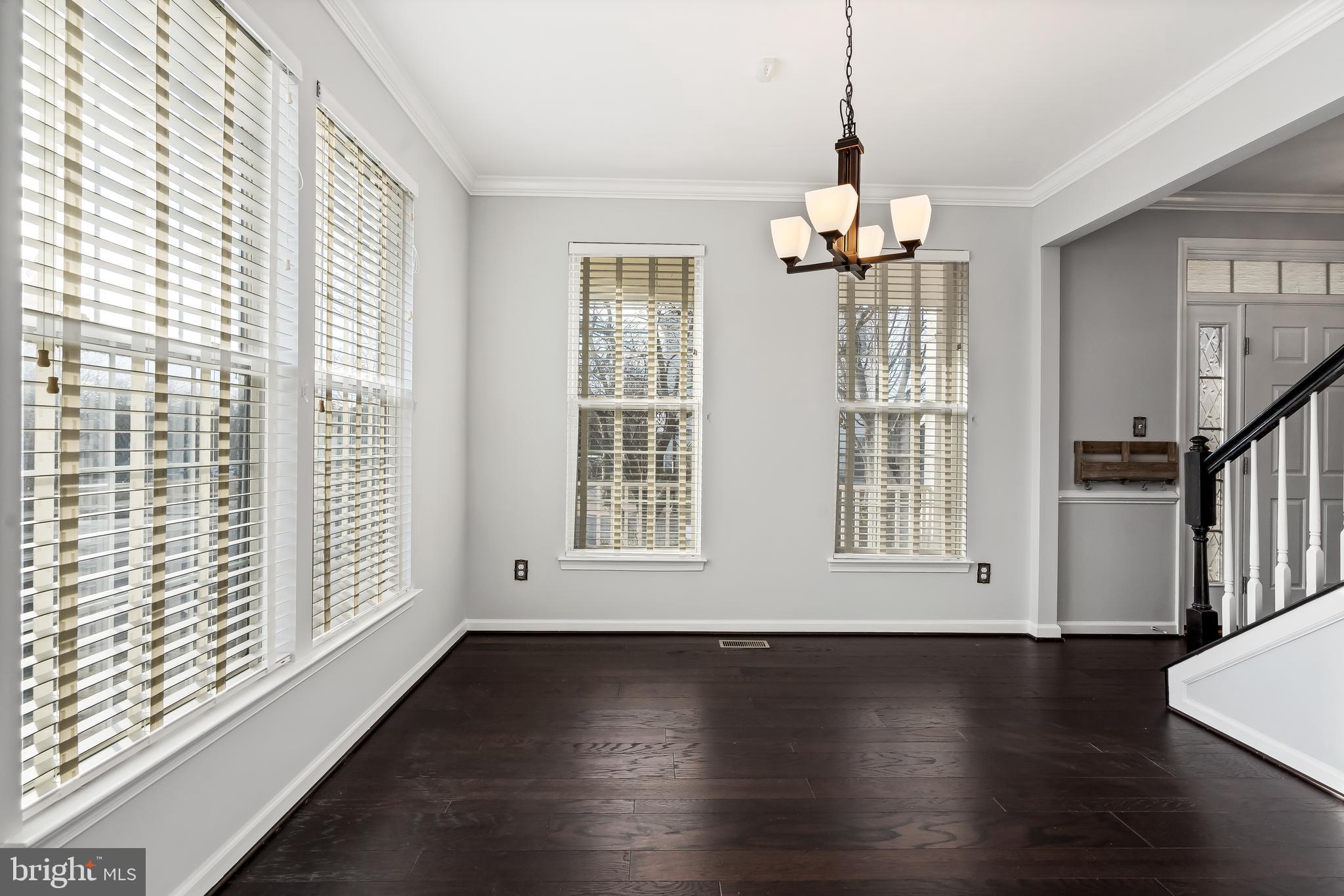 43112 Demerrit Street Chantilly, VA 20152 - Photo 16 of 42 a view of a room with wooden floor chandelier and windows
