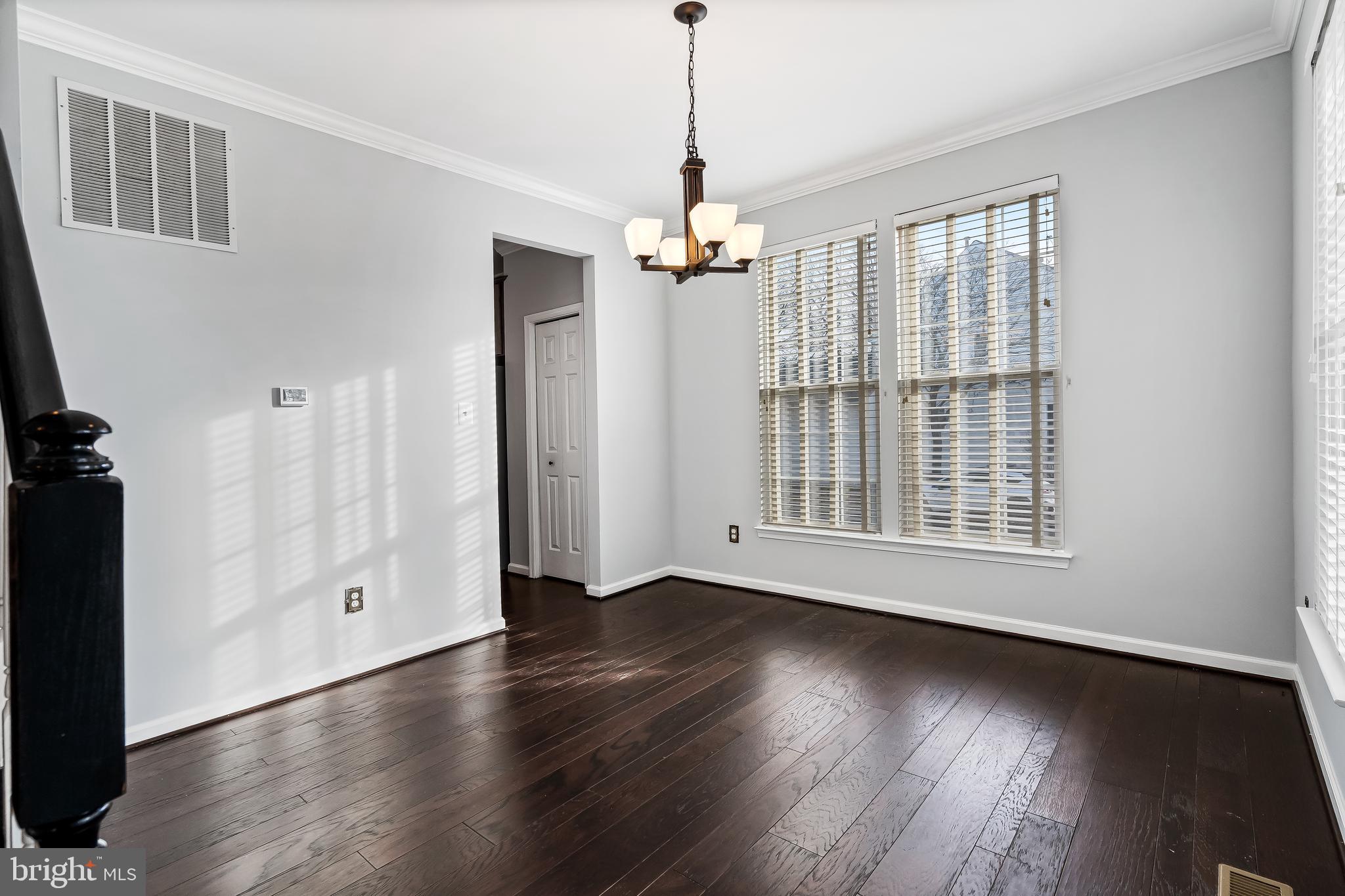43112 Demerrit Street Chantilly, VA 20152 - Photo 17 of 42 a view of a livingroom with wooden floor and a ceiling fan