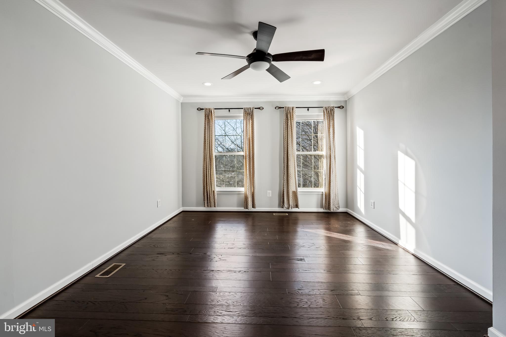 43112 Demerrit Street Chantilly, VA 20152 - Photo 24 of 42 a view of an empty room with wooden floor and a window