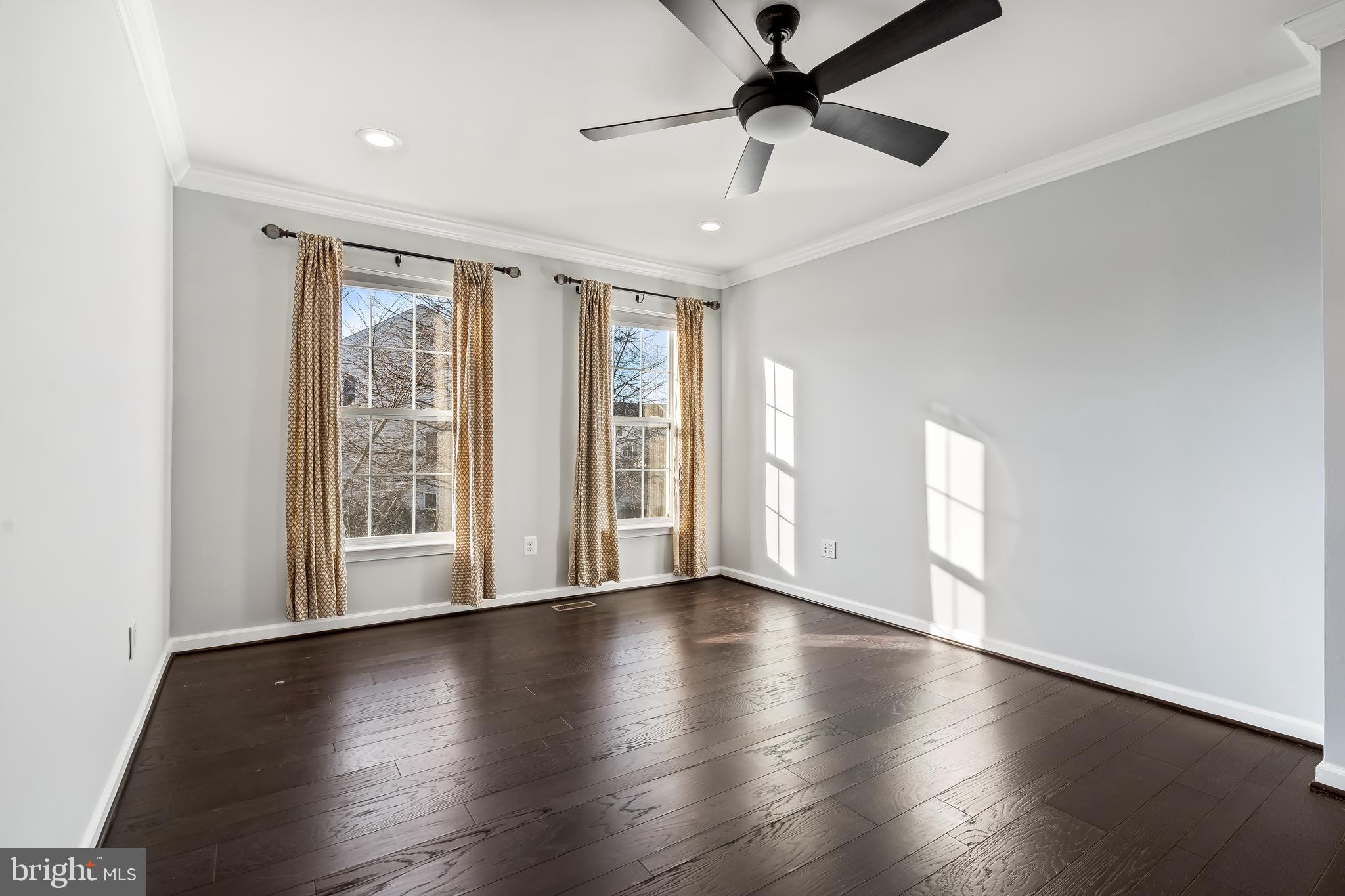 43112 Demerrit Street Chantilly, VA 20152 - Photo 25 of 42 a view of an empty room with wooden floor and a window