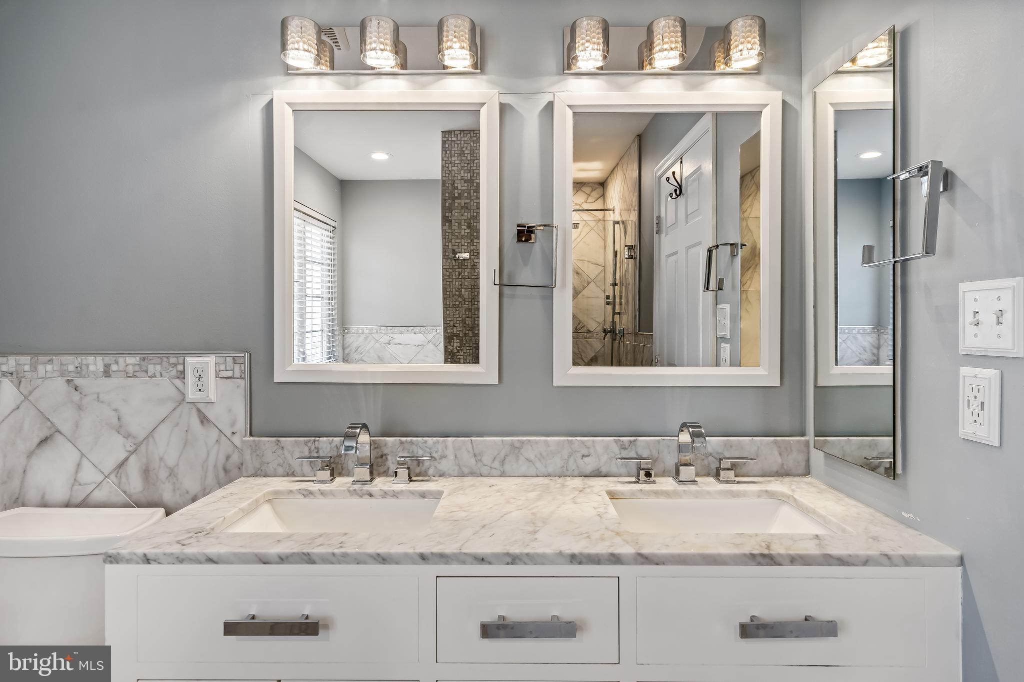 43112 Demerrit Street Chantilly, VA 20152 - Photo 28 of 42 a bathroom with a granite countertop sink and a mirror