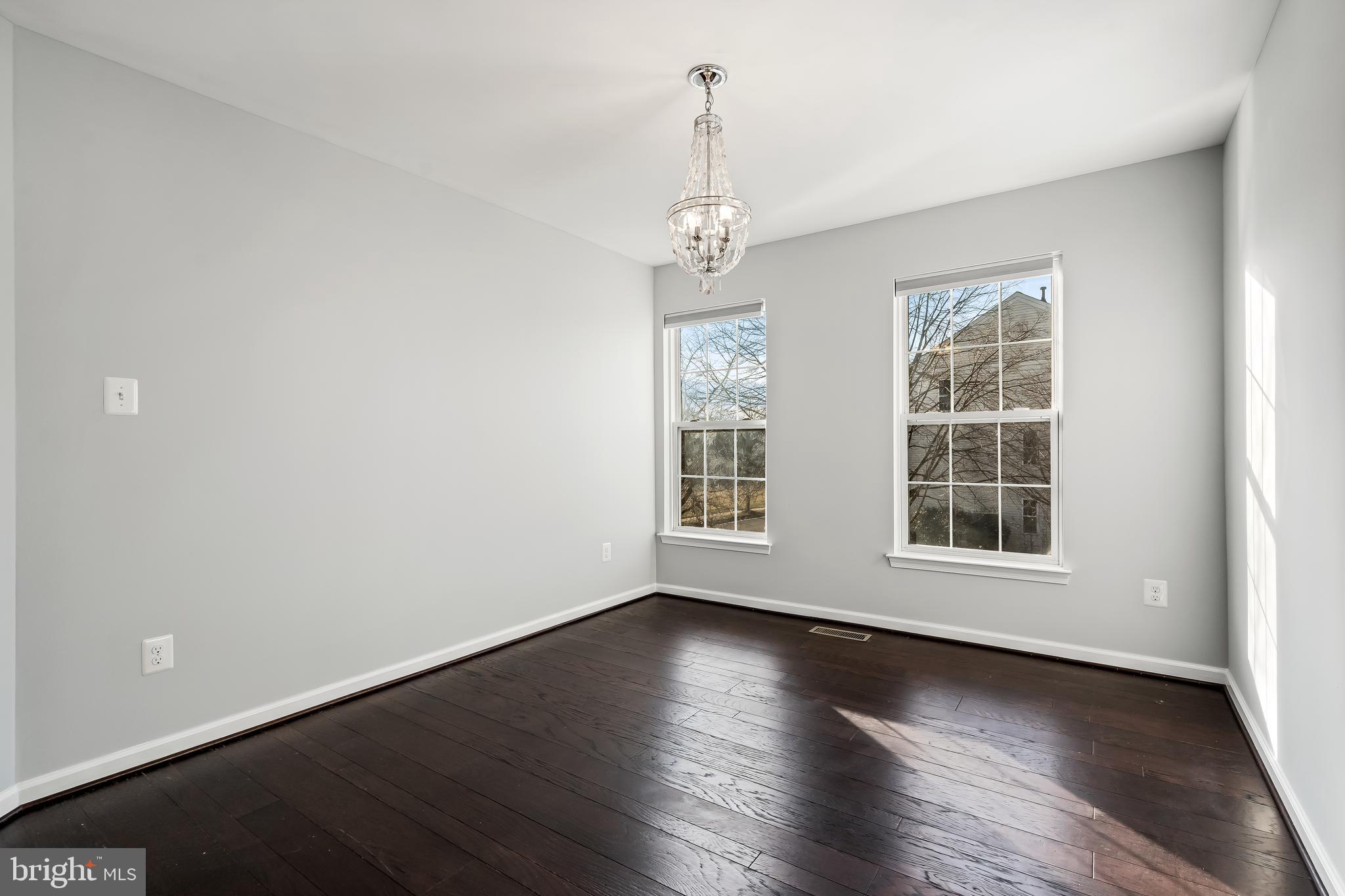 43112 Demerrit Street Chantilly, VA 20152 - Photo 30 of 42 an empty room with wooden floor and windows