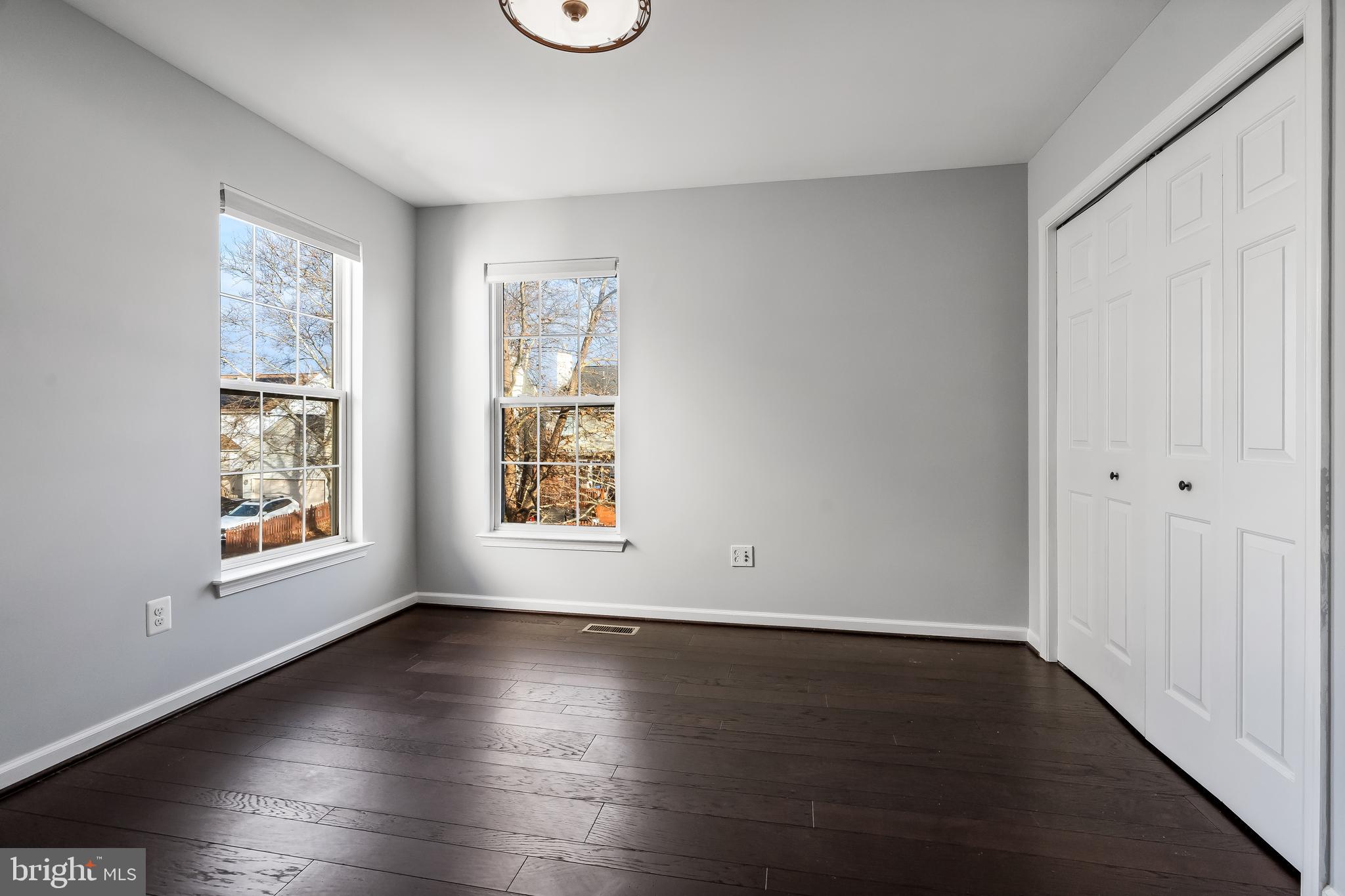 43112 Demerrit Street Chantilly, VA 20152 - Photo 31 of 42 an empty room with wooden floor and windows