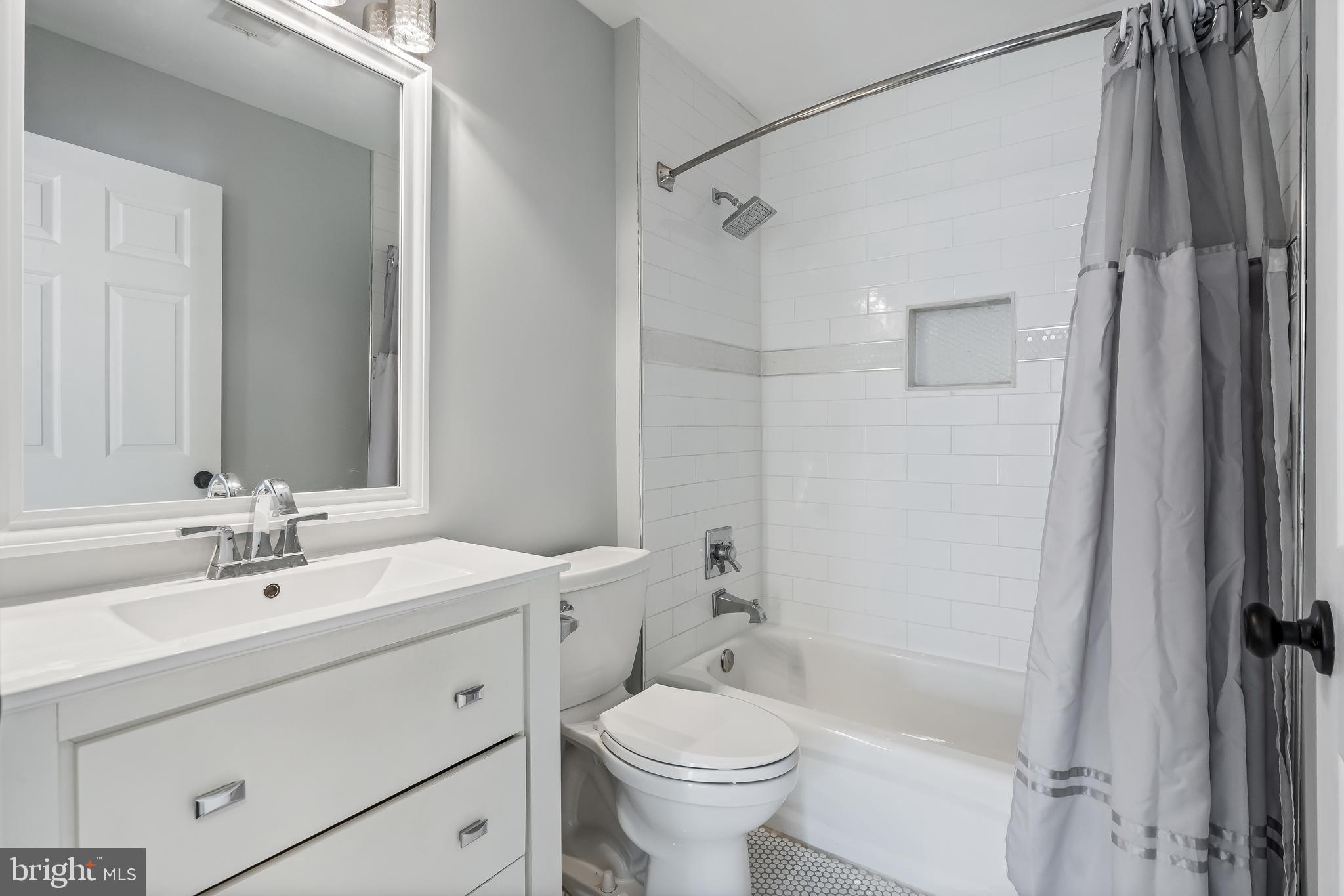 43112 Demerrit Street Chantilly, VA 20152 - Photo 33 of 42 a bathroom with a sink toilet and shower