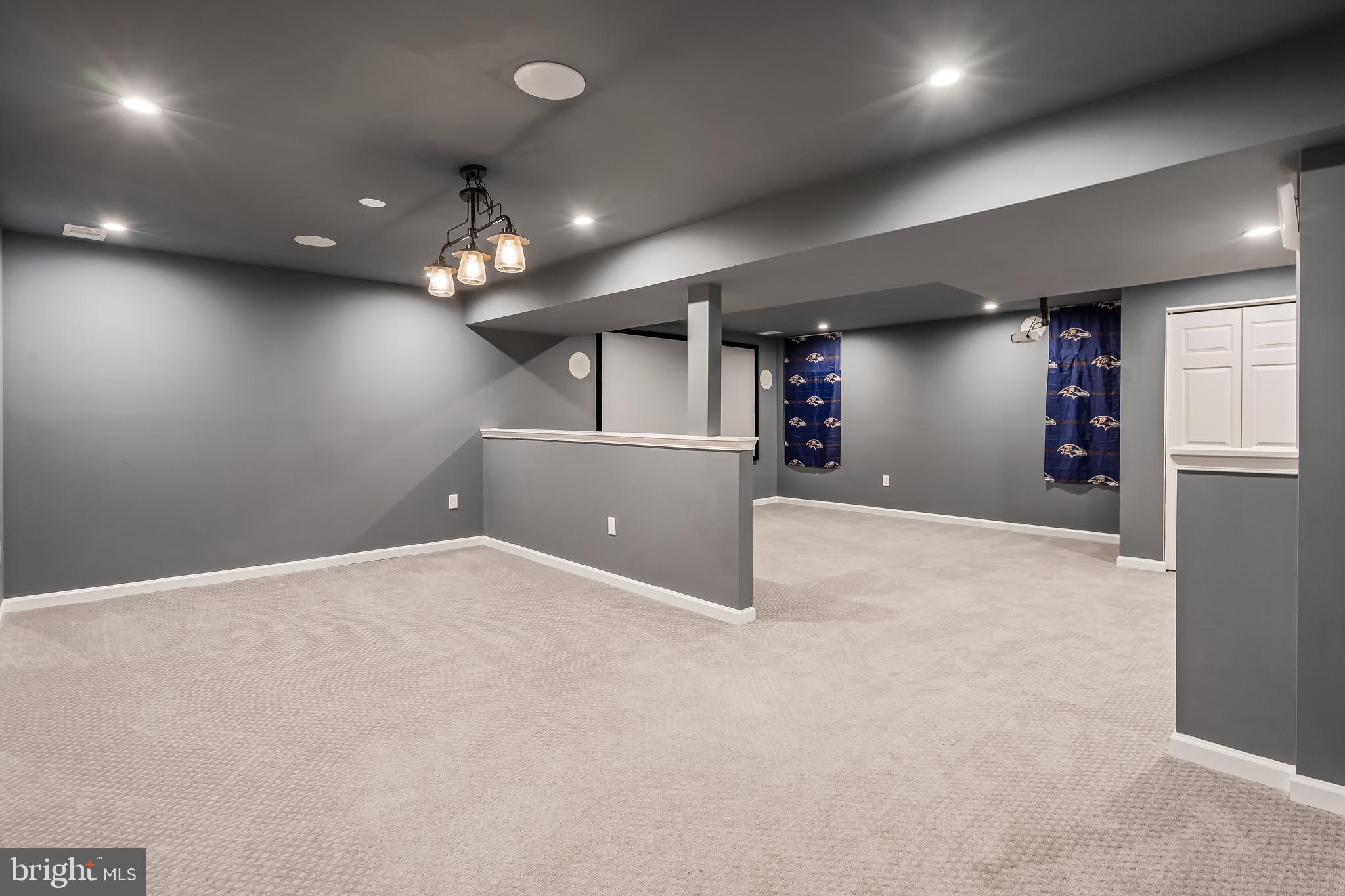 43112 Demerrit Street Chantilly, VA 20152 - Photo 34 of 42 an empty room with a chandelier and windows