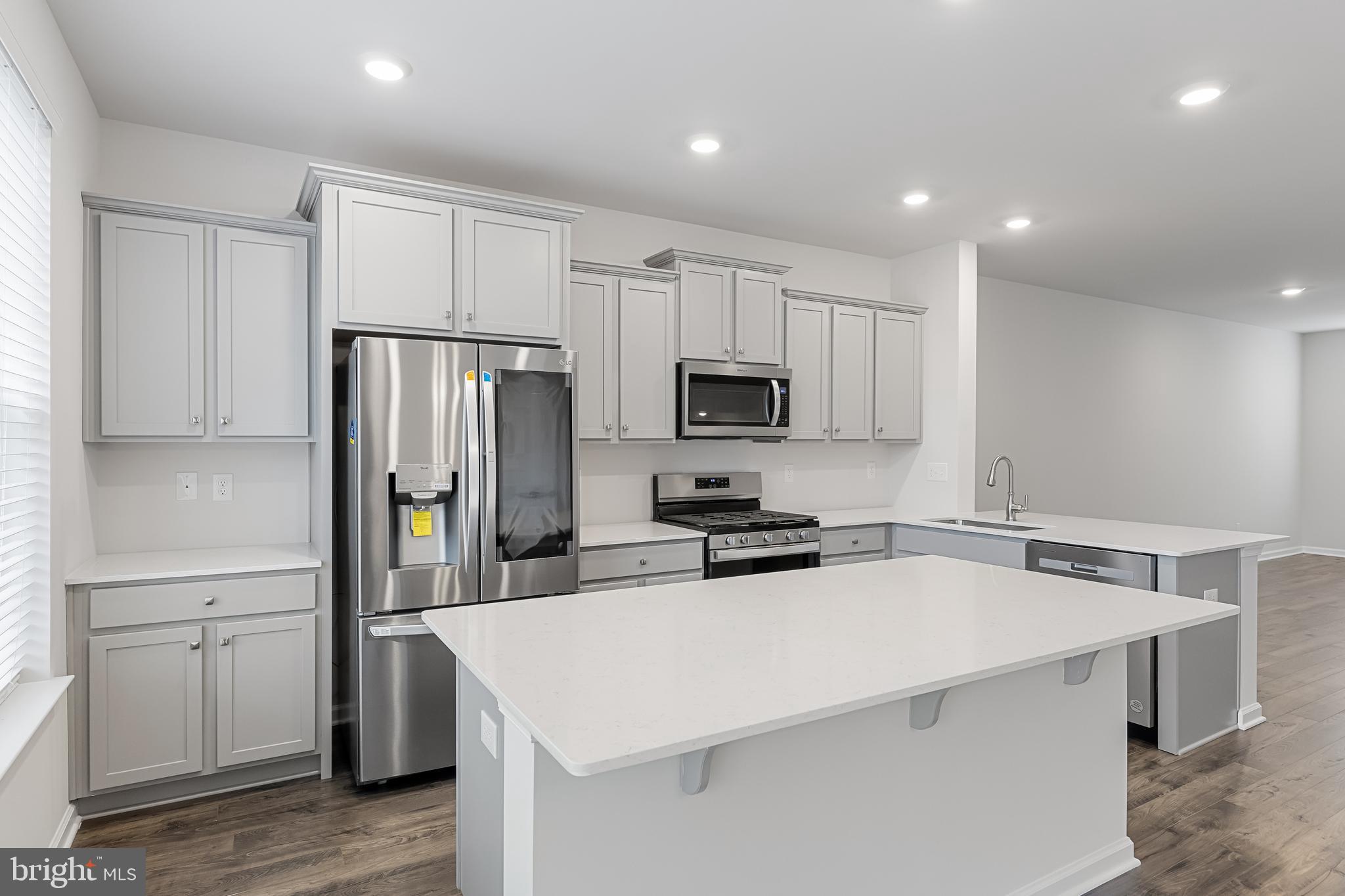 10 Sisters Farmstead Road Mount Laurel, NJ 08054 - Photo 16 of 35 a kitchen that has a refrigerator a sink and white cabinets