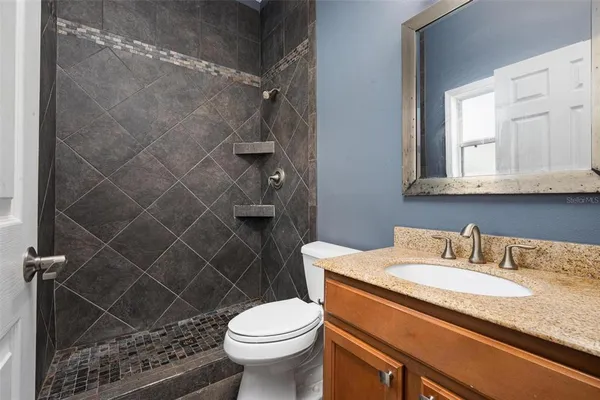 a bathroom with a sink toilet and shower