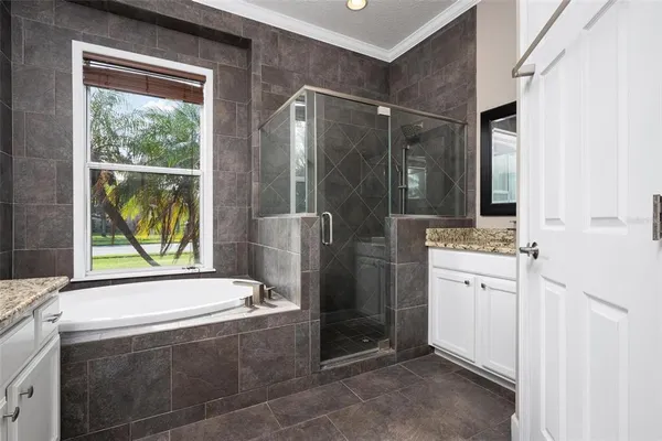 a bathroom with a tub sink and mirror