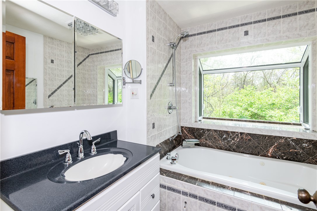 6750 Little Twin Road Germantown, OH 45327 - Photo 31 of 88 This bathroom features a deep soaking tub and a vanity with elegant stone counters.