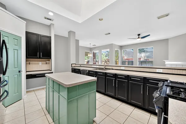 a kitchen with stainless steel appliances granite countertop a sink and a refrigerator