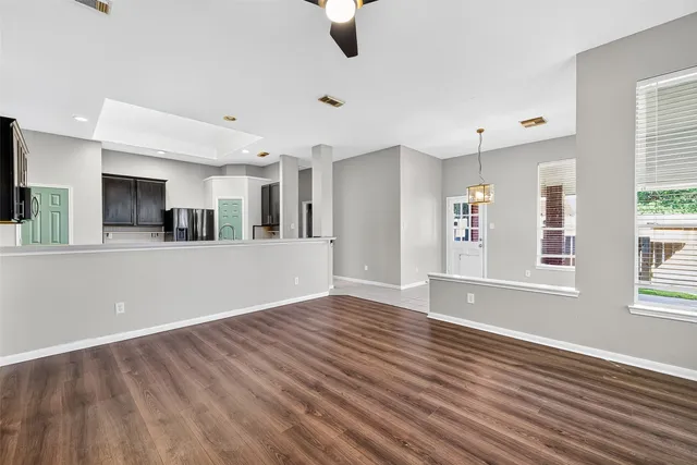 wooden floor in an empty room with a window