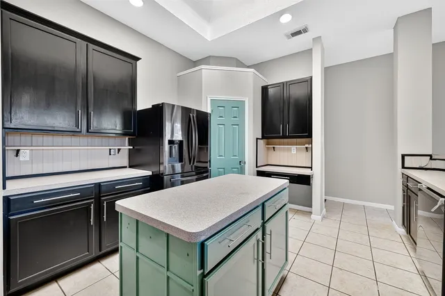 a kitchen with a stove refrigerator and microwave