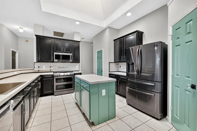 a kitchen with stainless steel appliances cabinets a stove top oven and stainless steel appliances