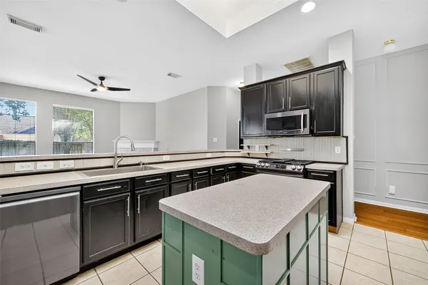 a kitchen with a stove a sink and a microwave
