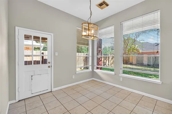 a view of an empty room with windows
